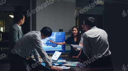 Preview: Asia businessmen and businesswomen meeting brainstorming ideas in small modern night office.