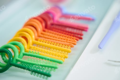 Preview: Close up of rainbow set of consumables for orthodontics
