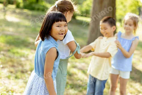 Preview: Group of asian and caucasian kids having fun in the park