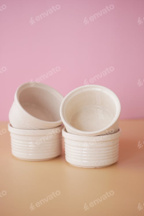 Preview: A lovely composition of stacked white ceramics beautifully placed on a soft pink background