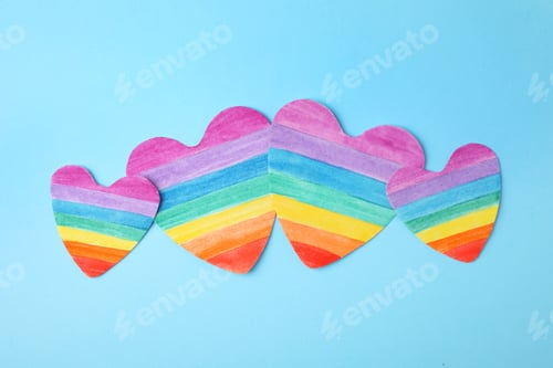 Preview: Rainbow hearts on color background, top view. Gay symbol