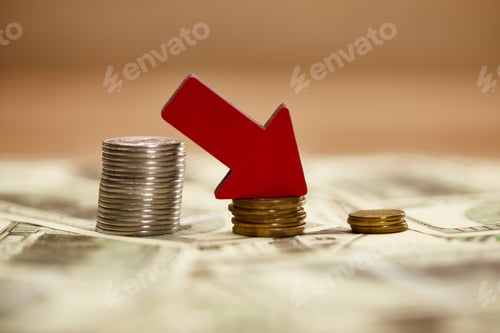Preview: selective focus of decreasing chart made of coins with red arrow on dollar banknotes, bankruptcy