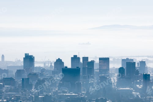 Preview: General view of cityscape with multiple modern buildings and skyscrapers in the foggy morning