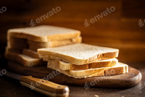 Preview: White sliced toast bread on wooden table.