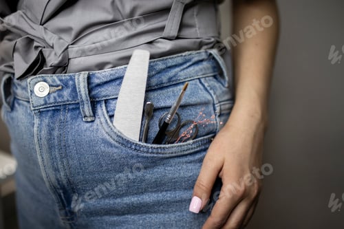 Preview: a manicure master holding tools and equipment to make nails procedure