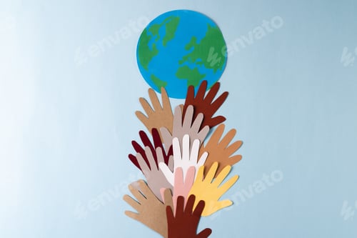Preview: Paper cut out of multi coloured hands with globe and copy space on blue background