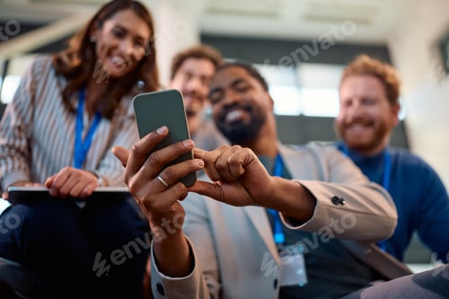 Preview: Close up of black entrepreneur talking selfie with is coworkers during a business conference.