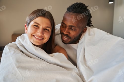 Preview: Happy woman and romantic man seated in bed