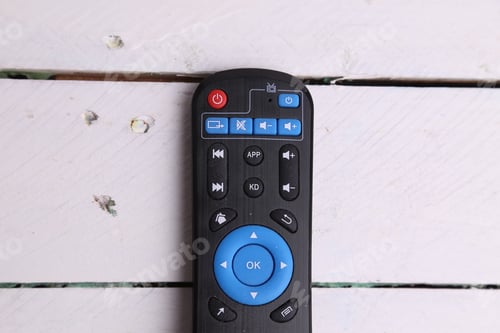Preview: Closeup shot of TV remote control on wooden background