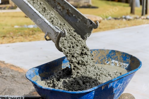 Preview: Concrete mixer truck pouring wet cement into wheelbarrow in construction site