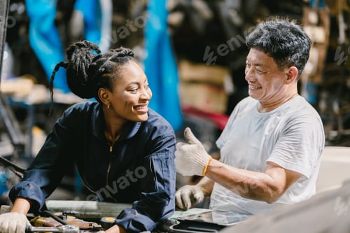 Preview: Engineer team working together helping fix service broken car. Women mechanic training in Garage wor