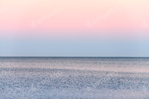 Preview: Atmospheric romantic pink red sea sunset sky above blue quiet water, minimalistic peaceful seascape