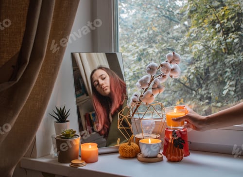 Preview: Girl decorates the window sill in her room for the holiday