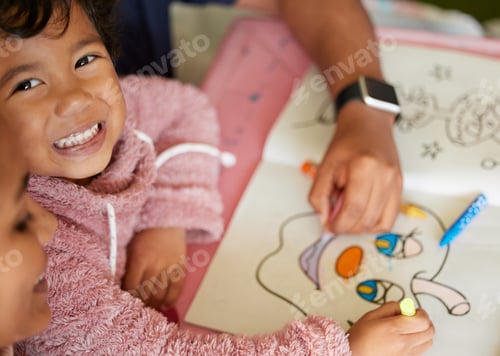 Preview: Shot of a little girl and her mother colouring in a book