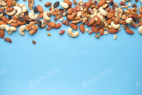Preview: close up of many mixed nuts on blue background