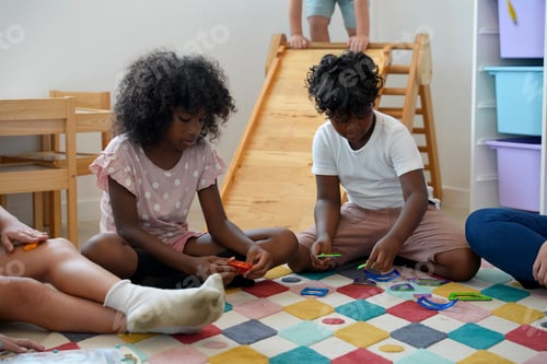 Preview: Children engage in creative playtime with colorful building toys on a carpeted floor