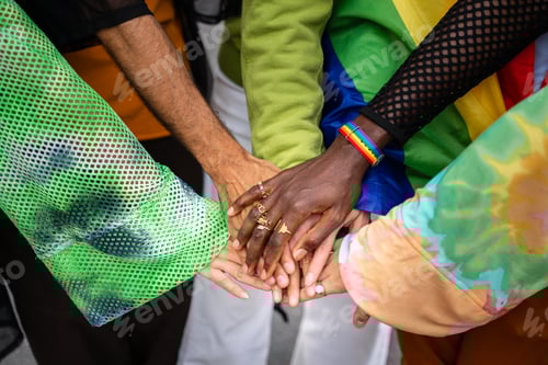 Preview: Young diverse people putting their hands together. Gay and LGTB Friends showing unity and teamwork