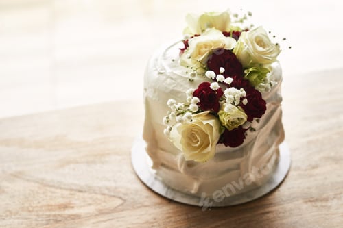 Preview: Still life shot of a beautiful wedding cake on top of a wooden surface