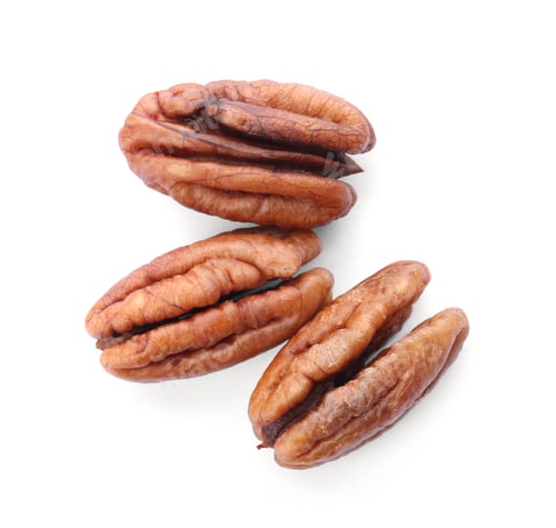 Preview: Shelled pecan nuts on white background, top view