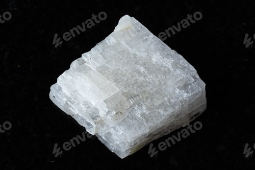 Preview: sample of raw colorless calcite mineral on black