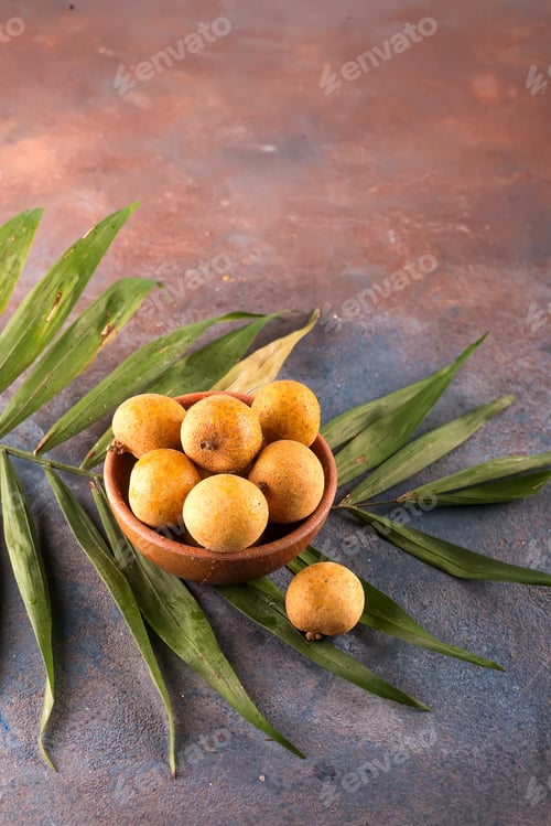 Preview: Tropical fruit longan in the bamboo basket on stone background
