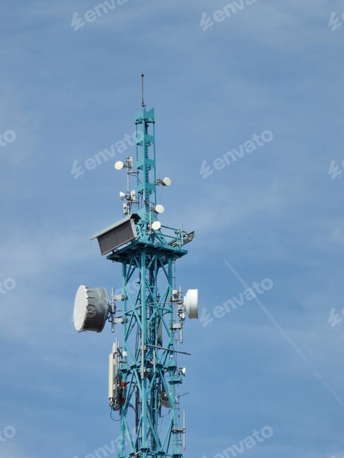Preview: Vertical shot of Communications tower for Television and Mobile Phone signals on a blue sky backg