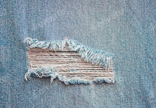 Preview: Light Blue jeans texture with a hole and threads.
