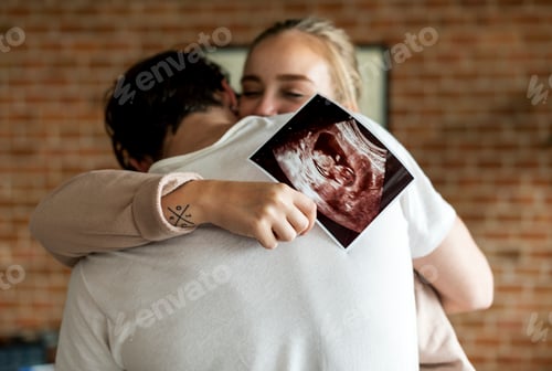 Preview: White couple with baby ultrasound photo