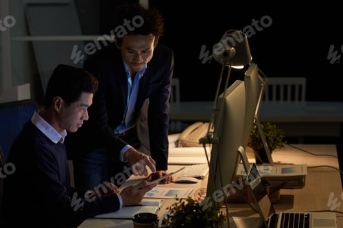 Preview: Asian businessmen working late in office