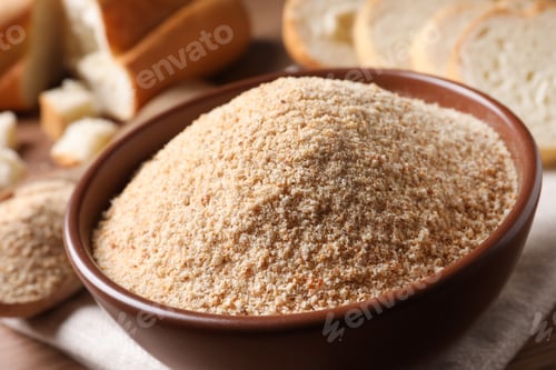Preview: Fresh bread crumbs in bowl on table, closeup