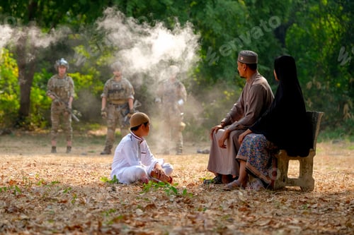 Preview: Muslim family sit near the jungle and look to soldier team with the concept of people during war
