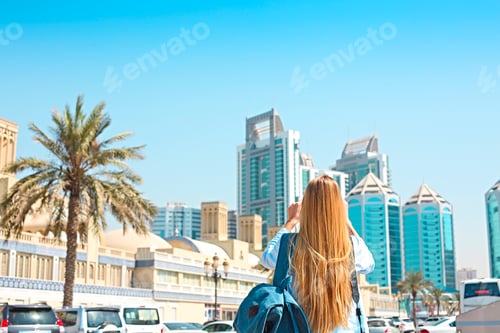 Preview: Woman taking mobile photo of the Central Souq in Sharjah City, United Arab Emirates