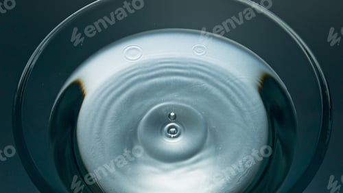 Preview: Macro aqua drop flowing refreshing drink. Falling blob liquid diverging circles