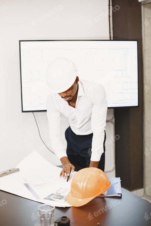 Preview: Young manager in the office with helmet