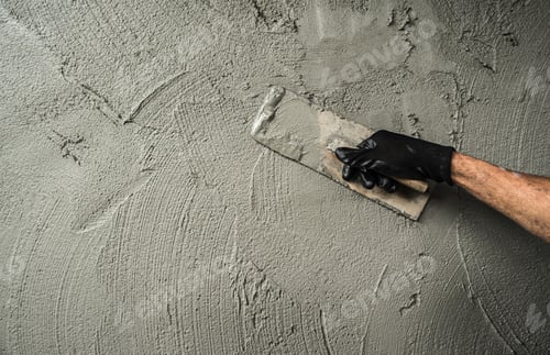 Preview: Hand worker plaster cement wall background with hand holding work trowel handle