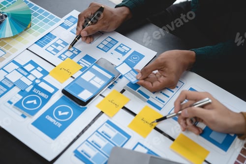 Preview: ux developers, UI designers Asian group data researchers brainstorm on tabletop mobile app interface