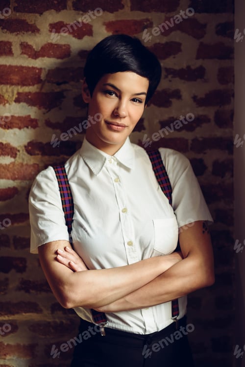 Preview: Beautiful young woman with very short haircut, looking at camera