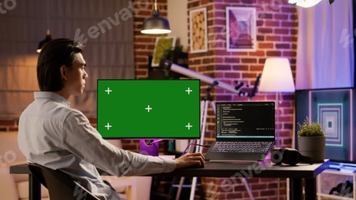 Preview: Office employee analyzing greenscreen on computer monitor