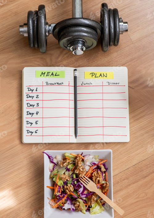 Preview: Meal plan notebook, dumbbells, and a healthy salad for a holistic approach to fitness.