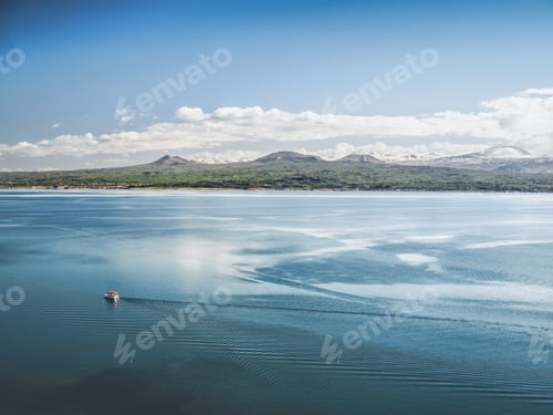 Preview: aerial view of boat floating on lake with mountains on background, Armenia