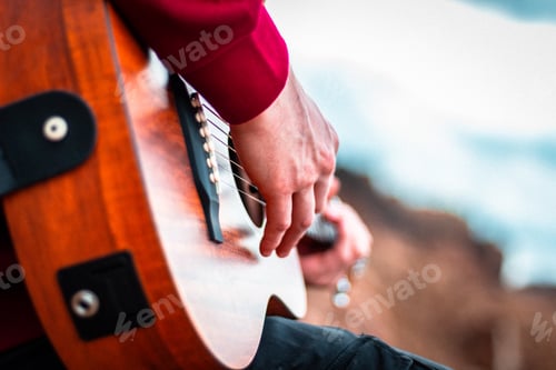 Preview: Closeup shot of hands playing acoustic guitar