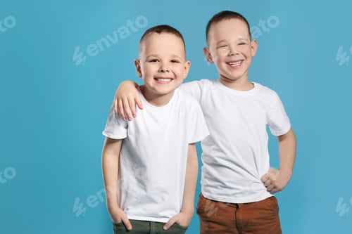 Preview: Portrait of cute twin brothers on color background