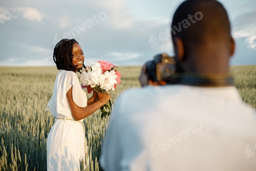 Preview: Happy couple with camera at summer field