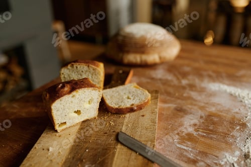 Preview: Sliced healthy wheat bread loaf on kitchen wooden board