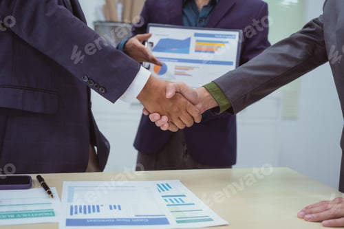 Preview: Close-up of business people shaking hands during meeting in the office,discussing analyzing charts