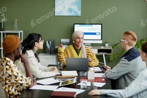 Preview: Smiling Female Manager Talking to Young Team