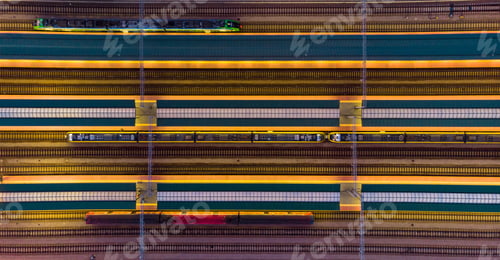 Preview: Illuminated platforms at rail station, top down aerial view