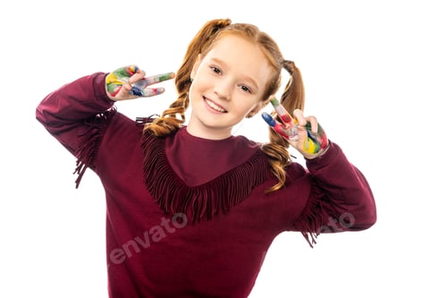 Preview: smiling schoolgirl looking at camera and showing peace signs with hands painted in colorful paints