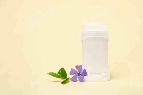 Preview: White deodorant and herbs purple flower on light background, copy space