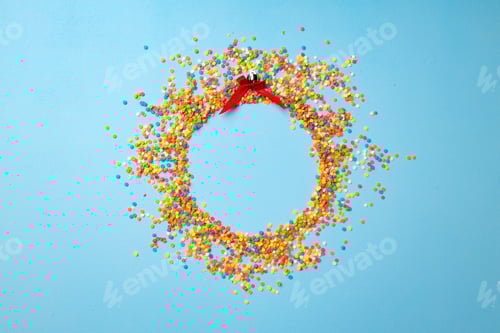 Preview: Christmas ball made of confetti on blue background flat lay